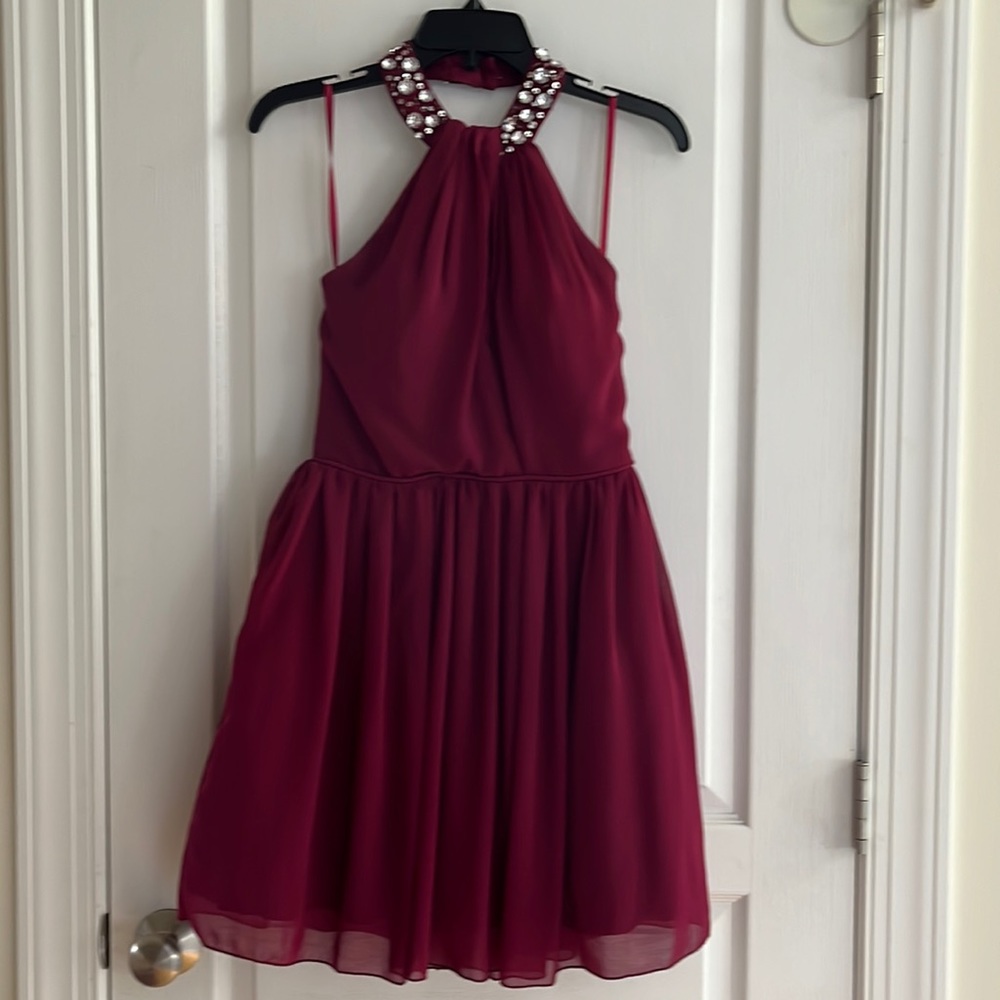 Short bright wine colored cocktail dress with high, jeweled neckline